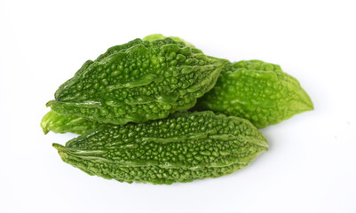 Closeup view of bitter gourd over vegetable garden concept on a white background