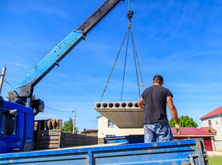 A crane raised a concrete slab at a construction site at home