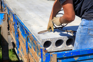 Installing concrete slabs at a construction site at home