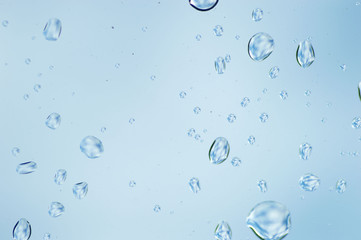 Water drops of rain on blue glass background