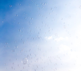 Soap bubbles fly in the blue sky