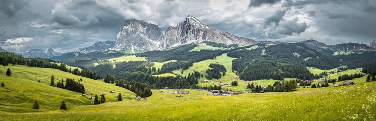 Seiser Alm (Alpe di Siusi) with Langkofel mountain at a cloudy day, Italy