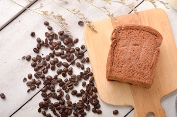 Coffee Bread and Coffee Bean for breakfast on wooden background