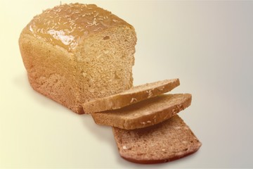 Brown bread loaf  with slices isolated on white