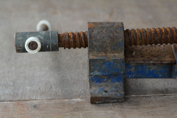 Old clamp use for clamped pieces of wood in carpentry workshop.