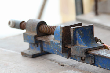 Old clamp use for clamped pieces of wood in carpentry workshop.
