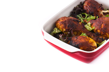Roasted tandoori chicken with herbs isolated on white background. Copyspace