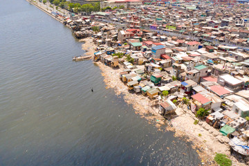 Slums in Manila, a top view. Sea pollution by household waste. Plastic trash on the beach.