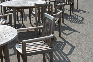 Wooden outdoor furniture set near a rest area in a zoo without anyone during sprint time and a sunshine.