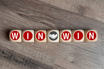 Cubes and dice with handshake icon and win-win-situation