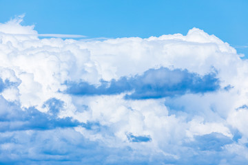 The vivid sky or heaven background with white and blue clouds under the sun rays