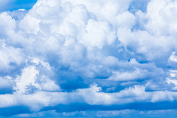 The vivid sky or heaven background with white and blue clouds under the sun rays