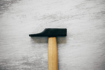 Hammer on wooden background. Construction and carpentry tools. Close up view of iron hammer with...