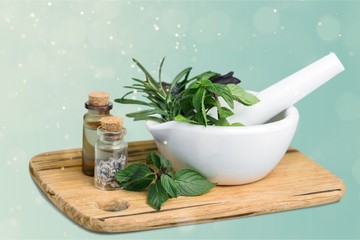 Obraz na płótnie Canvas Fresh herbs in the mortar - alternative medicine