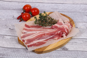 Raw bacon on the board