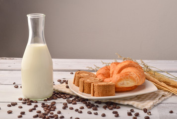 Bread and milk  for breakfast on wooden background