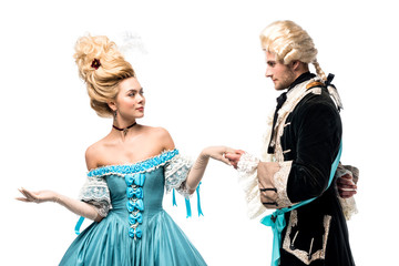 handsome gentleman holding hands with attractive victorian woman in blue dress isolated on white