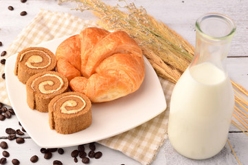 Bread and milk  for breakfast on wooden background