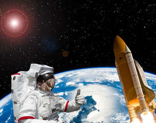 Astronaut and rocket above the earth. Space concept. The elements of this image furnished by NASA.
