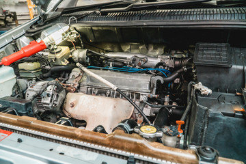 Fototapeta premium The bright photo of an automobile motor compartment close up
