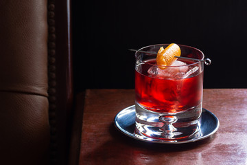 Negroni Cocktail, with Gin, Red Vermouth, and Campari, over Ice with Orange Twist in Dark Luxurious...