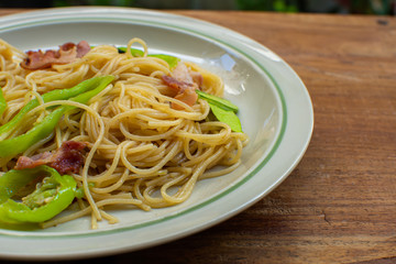 A dish of spaghetti on wooden table