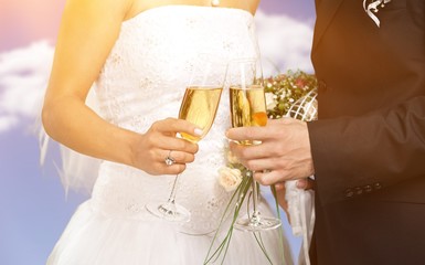 Happy just married young couple  with champagne