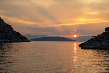 Summertime beautiful sunset as seen from the beach of Aponissos, Agistri island, Saronic gulf, Greece.