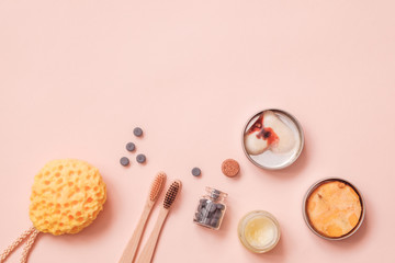 Solid Conditioner, Toothy Tabs, Bamboo Toothbrush, Natural Washing Sponge And Pressed Dry Shampoo on Light Color Table