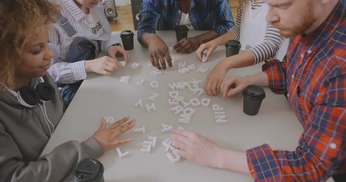 Diverse young people enjoying board game