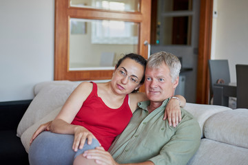 Middle-aged couple have a looking a TV at home