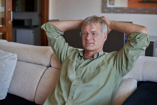 Middle-aged handsome man at home front of the camera