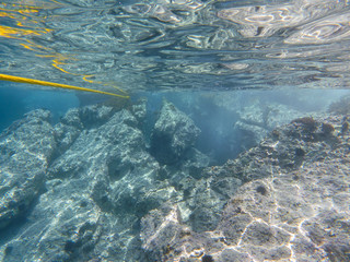 UNDERWATER sea level photo of the Aponissos beach, Agistri island, Saronic Gulf, Attica, Greece.