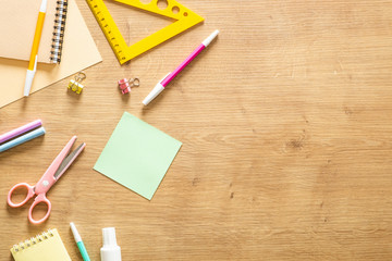 School stationery on a wooden background. Back to school concept. Flat lay style composition, top...