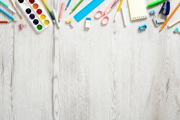 Back to school concept, creative layout with with various school supplies and stationery on wooden...