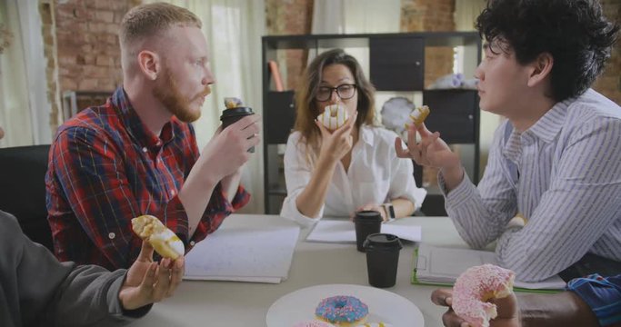 Business coworkers having coffee break in office