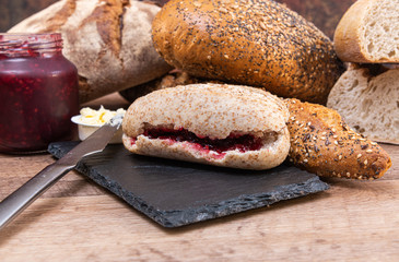 Bread with jam. Loaf of bread with jam on a black slate