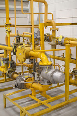 Yellow high-pressure gas pipeline pipes with adjustment sensors. Gas supply at the enterprise in...