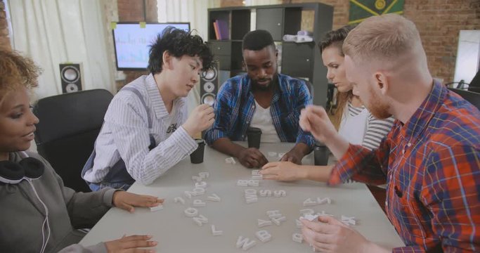 Happy friends playing table board game