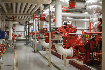 Fire safety in industry. The valve for water supply, fire extinguishing system and pipeline control is painted red.