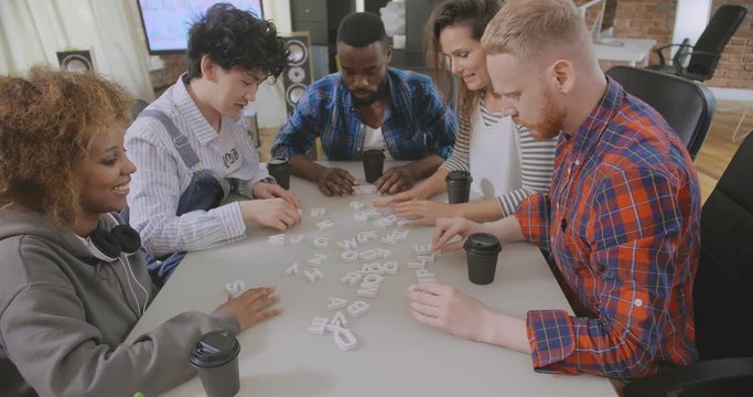 Cheerful hipster creative team having break