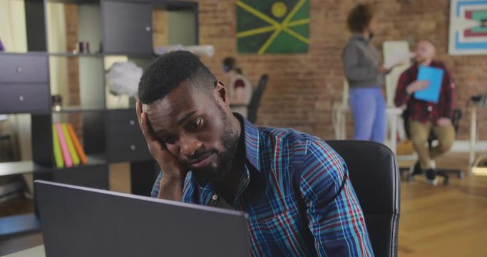 Portrait of african manager at boring work