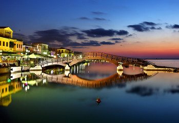 Sunset at Lefkas (Lefkada) town, at the small marina for the fishing boats with the nice wooden bridge.  Ionian sea, Greece.