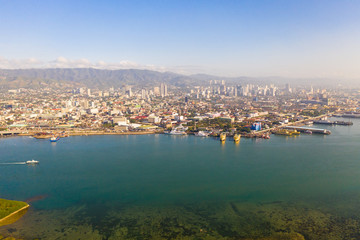 Cityscape in the morning. Streets and seaport of the city of Cebu, Philippines, top view. Panorama of the city with houses and business centers.