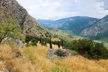 Fototapeta na wymiar Beautiful panoramic view to greek landscape, valley of Phosis and Parnassus mountain near ruins of ancient Delphi, Greece