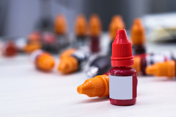 Bottles with inks for tattoo on table