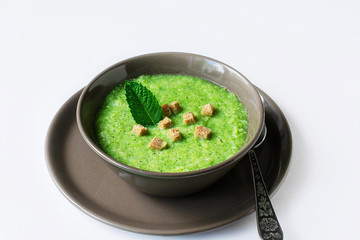 Vegetarian soup of broccoli puree on a white background. The concept of healthy eating.