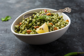 Hariyali sabudana khichdi is a delicious twist to the regular Sago khichadi made using cilantro , chillies and groundnuts