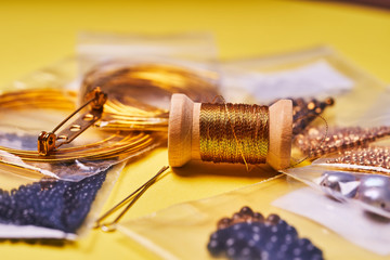 Embroidery products and tools. The spool of metallic thread, Japanese seed beads and sequins on a...
