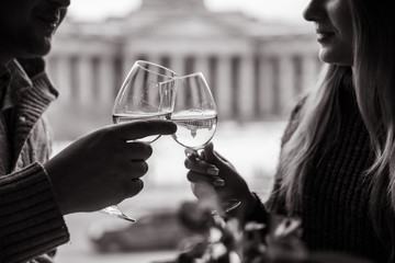 Couple clink glasses of champagne on a beautiful summer terrace. sparkling champagne glasses. close up